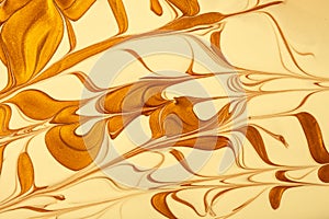 Abstract fluid art background golden and yellow colors. Liquid marble. Acrylic painting with swirl beige gradient