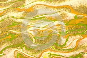 Abstract fluid art background green and yellow colors. Liquid marble. Acrylic painting with golden lines and gradient