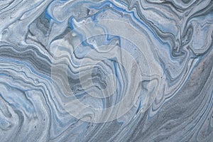 Abstract fluid art background light blue and gray colors. Liquid marble. Acrylic painting with silver gradient