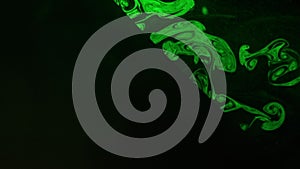 Abstract Forms Of Smoke On Black Background. Light Green Color Illuminates The Smoke.