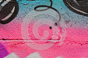 Abstract fragment of wall with detal of graffiti, old chipped paint, scratch, grunge texture. Aerosol design, pink-blue photo