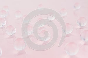 Abstract gentle pink background -  transparent glass balls on pastel backdrop.