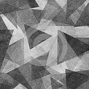 Abstract geometric background design with black and white triangle shapes layered in modern abstract pattern with texture