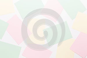 Abstract geometric background in light pastel tones from sheets of thick pale past paper