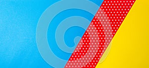 Abstract geometric blue, yellow and red polka dot paper background.