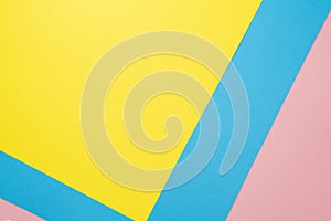 Abstract geometric paper background. Flat lay on pastel blue, pink and yellow trend colors texture.Top view