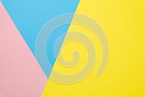 Abstract geometric paper background. Flat lay on pastel blue, pink and yellow trend colors texture.Top view