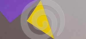 Abstract geometric paper texture cardboard background. Top view of purple violet yellow gray trendy colors tones