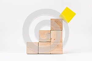 Abstract geometric real wooden cube pyramid on white floor background. It`s the symbol of make a mistake, fall into a trap