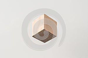 Abstract geometric real wooden cube with surreal layout on white background