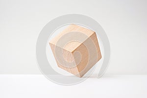 Abstract geometric real wooden cube with surreal layout on white background