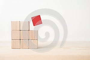 Abstract geometric real wooden cube with surreal layout on white floor background and it`s not 3D render. It`s the symbol of lea