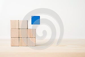 Abstract geometric real wooden cube with surreal layout on white floor background and it`s not 3D render. It`s the symbol of lea