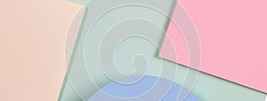 Abstract geometric texture background of soft green, pastel pink, light blue, yellow color paper. Top view, flat lay