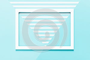 Abstract geometrical baby pastel blue flat lay background. Minimalism, geometry and symmetry template with empty picture frame.