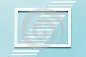 Abstract geometrical baby pastel blue flat lay background. Minimalism, geometry and symmetry template with empty picture frame.