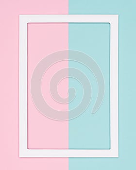 Abstract geometrical pastel blue and pink colored paper flat lay background. Minimalism template with empty picture frame.