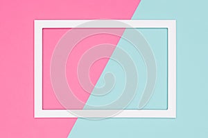 Abstract geometrical pastel blue and pink colored paper flat lay background. Minimalism template with empty picture frame.