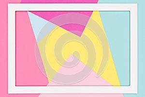 Abstract geometrical pastel blue, yellow and pink paper flat lay background. Minimalism, geometry template with picture frame.