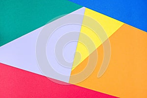 Abstract geometrical pattern made from green, violet, blue, red, orange and yellow paper, blank background for template,