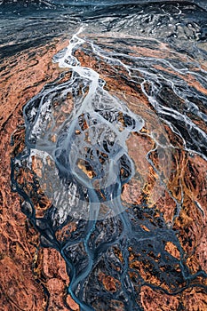 Abstract glacier rivers pattern flowing through volcanic lava field in Icelandic highlands on summer