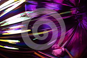 Abstract glass surface. Vivid purple and pink background with rainbow colored light reflections