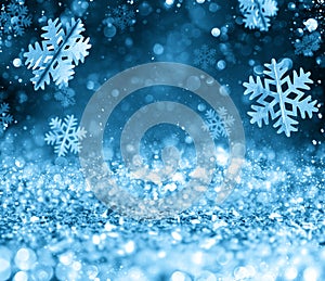 Abstract glowing Christmas blue background with snowflakes