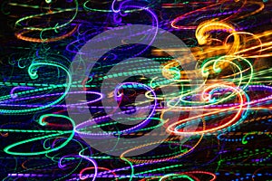 Abstract glowing multicolored swirls on black background.