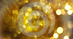 Abstract gold bokeh background. Golden holiday glowing backdrop. Defocused Background With Blinking Stars. Blurred Bokeh