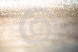 Abstract gold glitter bokeh lights with soft light background