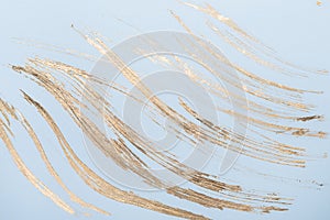 Abstract Gold potal brush strokes on blue pastel paper background or texture photo