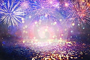 Abstract gold, purple and blue glitter background with fireworks. christmas eve, 4th of july holiday concept