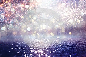 Abstract gold, purple and silver glitter background with fireworks. christmas eve, 4th of july holiday concept