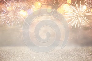 abstract gold and silver glitter background with fireworks. christmas eve, 4th of july holiday concept.