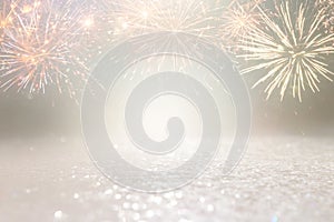 Abstract gold and silver glitter background with fireworks. christmas eve, 4th of july holiday concept