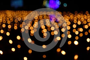 Abstract golden bokeh from candle light on black background