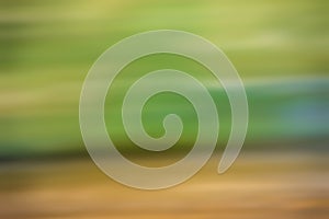 Abstract gradient blue, green and brown light background texture with horizontal motion blur