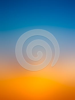 Abstract gradient sunrise in sky with blue and orange natural background