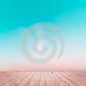 Abstract gradient sunrise in sky with old wood floor background