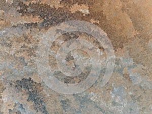 Abstract grainy brown, gray and white background. Chaotic stains and streaks, similar to Chinese painting. Light pastel backdrop