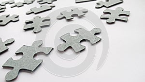 Abstract gray jigsaw puzzle pieces on white background