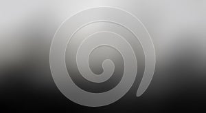 Abstract grayscale gradient background with blurred pixelated texture