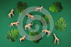 Abstract green background with tropical leaves and exotic animals