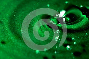Abstract green background with water, drops and waves macro