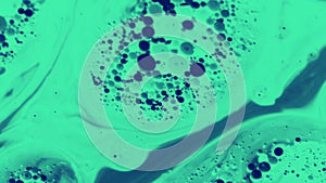 Abstract green and blue bubbles in liquid.