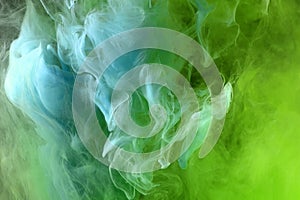 Abstract green and blue color background. Swirling vibrant hookah smoke, dynamic paint in water