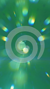 Abstract green glowing light rays and bokeh shapes creating dynamic energy burst background