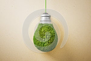 Abstract green grass light bulb on brown background. Eco concept and energy concept.