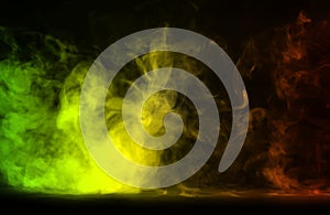Abstract green,orange and yellow Colorful smoke on a black background.