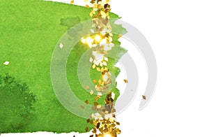 Abstract green watercolor splash and golden glitter on white background